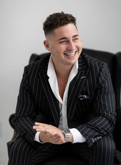 Charlie Rothkopf smiling in a pinstripe suit
