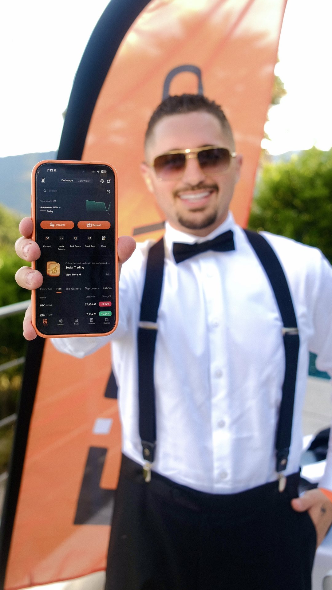 Charlie Rothkopf holding a phone showing the CZR Exchange app
